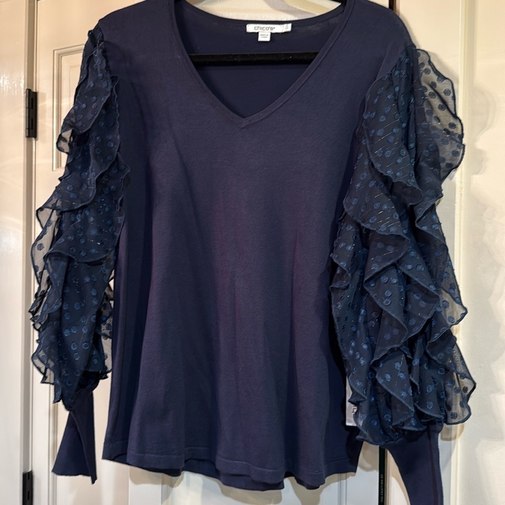 Chicos size 2 (large) v-neck sweater with a sheer ruffle sleeve in navy blue.